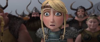 Movie still from “How to Train Your Dragon” (2010), directed by Chris Sanders – A cartoon character with a bunch of people in the background; Close Up shot, Over the shoulder angle