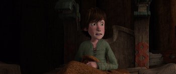 Movie still from “How to Train Your Dragon” (2010), directed by Chris Sanders – A boy is sitting in a bed with a blanket on the floor; Medium shot, High angle