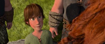 Movie still from “How to Train Your Dragon” (2010), directed by Chris Sanders – A boy and a man holding hands in a field; Medium shot, Over the shoulder angle