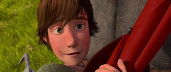 Movie still from “How to Train Your Dragon” (2010), directed by Chris Sanders – A person holding a red object; Close Up shot, Overhead angle
