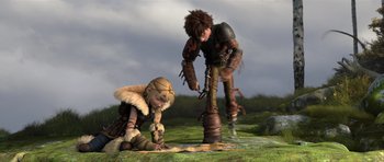 Movie still from “How to Train Your Dragon 2” (2014), directed by Dean DeBlois – A boy and a girl are playing a game on the grass; Wide shot, High angle