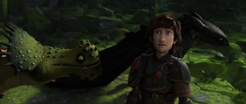 Movie still from “How to Train Your Dragon 2” (2014), directed by Dean DeBlois – A young boy standing in front of a green creature; Medium shot, High angle