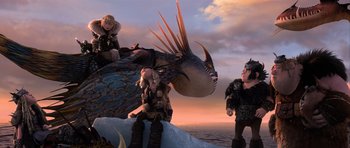 Movie still from “How to Train Your Dragon 2” (2014), directed by Dean DeBlois – A group of people standing next to each other near an ocean; Wide shot, Low angle