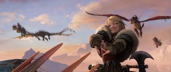 Movie still from “How to Train Your Dragon 2” (2014), directed by Dean DeBlois – A dragon flies over a woman in a brown coat; Medium shot, Low angle