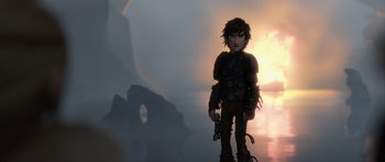 Movie still from “How to Train Your Dragon 2” (2014), directed by Dean DeBlois – A young boy standing in front of a sunset; Medium shot, Low angle