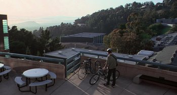 Movie still from “Hulk” (2003), directed by Ang Lee – A man standing next to two bicycles on a balcony; Extreme Wide shot, High angle