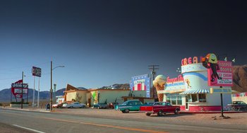 Movie still from “Hulk” (2003), directed by Ang Lee – A street scene with cars parked on the side of the road; Extreme Wide shot, Low angle