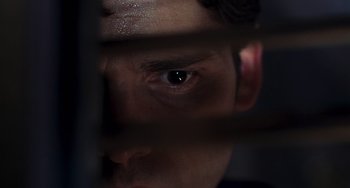 Movie still from “Hulk” (2003), directed by Ang Lee – A man's eyes looking through the bars of a window; Extreme Close Up shot, High angle