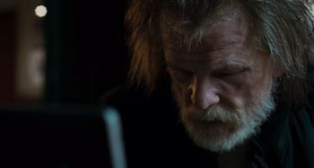 Movie still from “Hulk” (2003), directed by Ang Lee – An older man with a beard looking at a cell phone; Close Up shot, Low angle