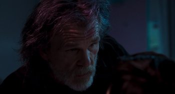 Movie still from “Hulk” (2003), directed by Ang Lee – An older man with purple hair looking at a cell phone; Close Up shot, Over the shoulder angle