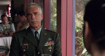 Movie still from “Hulk” (2003), directed by Ang Lee – An older man in a military uniform is posing for a picture; Close Up shot, Over the shoulder angle