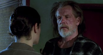 Movie still from “Hulk” (2003), directed by Ang Lee – An older man with long white hair and a long beard talking to a young woman; Close Up shot, Over the shoulder angle
