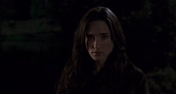 Movie still from “Hulk” (2003), directed by Ang Lee – A woman with long dark brown hair standing in the dark; Close Up shot, Over the shoulder angle