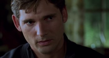 Movie still from “Hulk” (2003), directed by Ang Lee – A man's face in a black shirt; Close Up shot, Over the shoulder angle