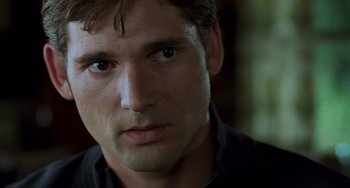 Movie still from “Hulk” (2003), directed by Ang Lee – A man's face in a black shirt; Close Up shot, Over the shoulder angle