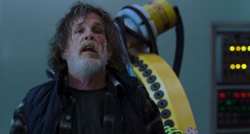 Movie still from “Hulk” (2003), directed by Ang Lee – An older man with a beard and a jacket on; Close Up shot, Low angle