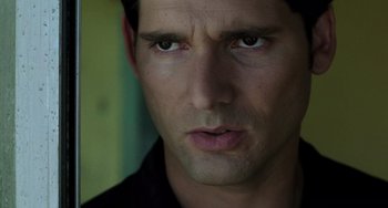 Movie still from “Hulk” (2003), directed by Ang Lee – A man's face in a black shirt; Close Up shot, Over the shoulder angle