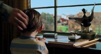 Movie still from “Hulk” (2003), directed by Ang Lee – A boy sitting at a desk looking out a window; Close Up shot, Over the shoulder angle