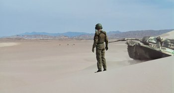 Movie still from “Hulk” (2003), directed by Ang Lee – A man in a military uniform is walking in the desert; Extreme Wide shot, Low angle