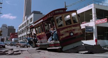 Movie still from “Hulk” (2003), directed by Ang Lee – A red trolley car is driving down the street; Extreme Wide shot, High angle