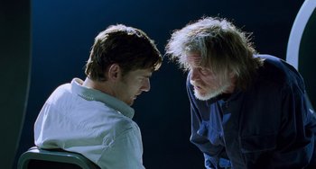 Movie still from “Hulk” (2003), directed by Ang Lee – Two men talking to each other in front of a dark background; Close Up shot, Over the shoulder angle