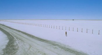 Movie still from “Hulk” (2003), directed by Ang Lee – A person standing in the middle of a snow covered field; Extreme Wide shot, High angle