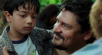 Movie still from “Hulk” (2003), directed by Ang Lee – A man and a boy are smiling for the camera; Close Up shot, Over the shoulder angle