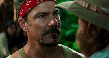 Movie still from “Hulk” (2003), directed by Ang Lee – A person with a beard wearing a bandana; Close Up shot, Over the shoulder angle
