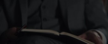 Movie still from “Hypnotic” (2021), directed by Matt Angel – An open book sitting on top of a bed in a dark room; Extreme Close Up shot, High angle