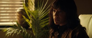 Movie still from “Hypnotic” (2023), directed by Robert Rodriguez – A person with a plant in the background; Close Up shot, Over the shoulder angle