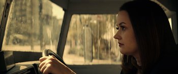 Movie still from “Hypnotic” (2023), directed by Robert Rodriguez – A woman sitting in the passenger seat of a car looking out the window; Close Up shot, Over the shoulder angle