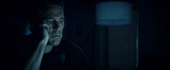 Movie still from “Hypnotic” (2023), directed by Robert Rodriguez – A person sitting in a dark room; Close Up shot, Low angle