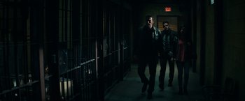 Movie still from “Hypnotic” (2023), directed by Robert Rodriguez – Two men are walking in a dark hallway; Wide shot, Low angle