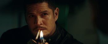 Movie still from “Hypnotic” (2023), directed by Robert Rodriguez – A person lighting a cigarette; Close Up shot, Over the shoulder angle