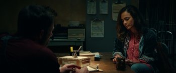 Movie still from “Hypnotic” (2023), directed by Robert Rodriguez – Two people are sitting at a table with papers; Medium shot, Over the shoulder angle