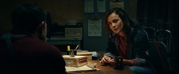 Movie still from “Hypnotic” (2023), directed by Robert Rodriguez – A woman sitting at a table with a cup of coffee; Medium shot, Over the shoulder angle