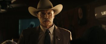 Movie still from “Hypnotic” (2023), directed by Robert Rodriguez – A man in a cowboy hat and a suit; Close Up shot, Low angle