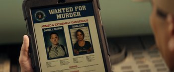 Movie still from “Hypnotic” (2023), directed by Robert Rodriguez – A wanted poster of a man and a woman; Close Up shot, Overhead angle