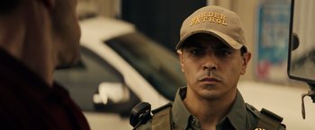 Movie still from “Hypnotic” (2023), directed by Robert Rodriguez – A man in a tan hat and a brown cap; Close Up shot, Low angle