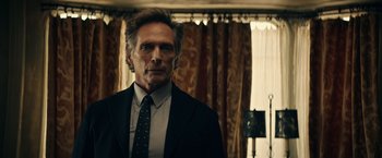 Movie still from “Hypnotic” (2023), directed by Robert Rodriguez – A person wearing a suit and tie; Close Up shot, Low angle