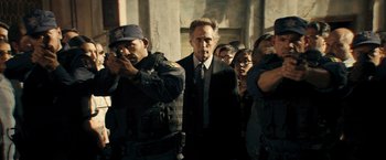 Movie still from “Hypnotic” (2023), directed by Robert Rodriguez – A group of people standing next to each other in a room; Medium shot, Low angle