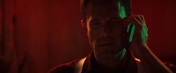 Movie still from “Hypnotic” (2023), directed by Robert Rodriguez – A person in a dark room; Close Up shot, Low angle