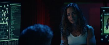Movie still from “Hypnotic” (2023), directed by Robert Rodriguez – A woman sitting at a table in a dark room; Close Up shot, Over the shoulder angle