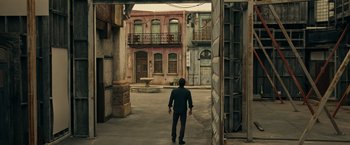 Movie still from “Hypnotic” (2023), directed by Robert Rodriguez – A man walking down a street in a city; Wide shot, High angle