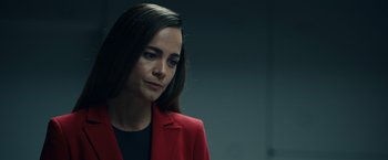 Movie still from “Hypnotic” (2023), directed by Robert Rodriguez – A woman wearing a red jacket looking to her left; Close Up shot, Over the shoulder angle