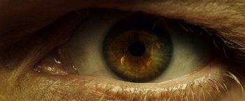 Movie still from “Hypnotic” (2023), directed by Robert Rodriguez – The eye of a person with brown eyes; Extreme Close Up shot, Overhead angle