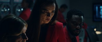 Movie still from “Hypnotic” (2023), directed by Robert Rodriguez – A woman in a red jacket is looking at the camera; Close Up shot, Low angle