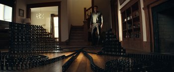 Movie still from “Hypnotic” (2023), directed by Robert Rodriguez – A man standing on the stairs of a house; Extreme Wide shot, Low angle