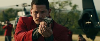 Movie still from “Hypnotic” (2023), directed by Robert Rodriguez – A man in a red jacket is holding a gun; Close Up shot, Over the shoulder angle