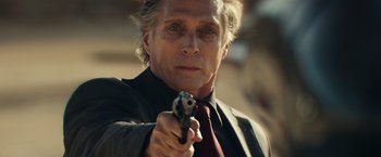 Movie still from “Hypnotic” (2023), directed by Robert Rodriguez – A person holding a gun; Close Up shot, Over the shoulder angle